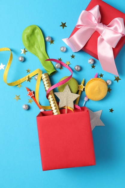 Gift box with Birthday accessories on blue background