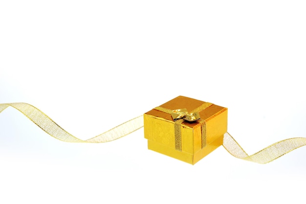 Gift box with gold ribbon bow isolated on white background with copy space