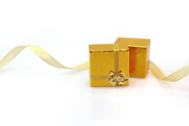 Gift box with gold ribbon bow isolated on white background with copy space