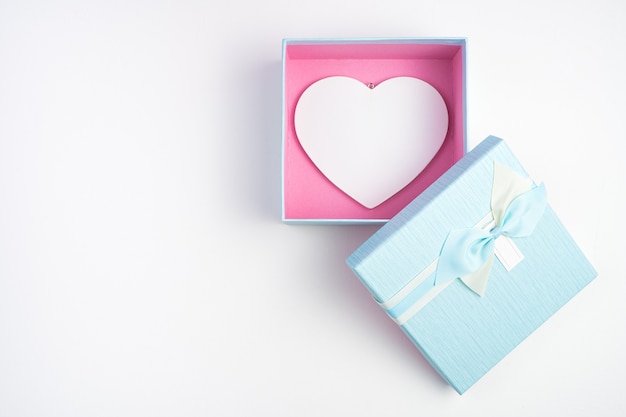 Gift box with a heart inside on a light background.