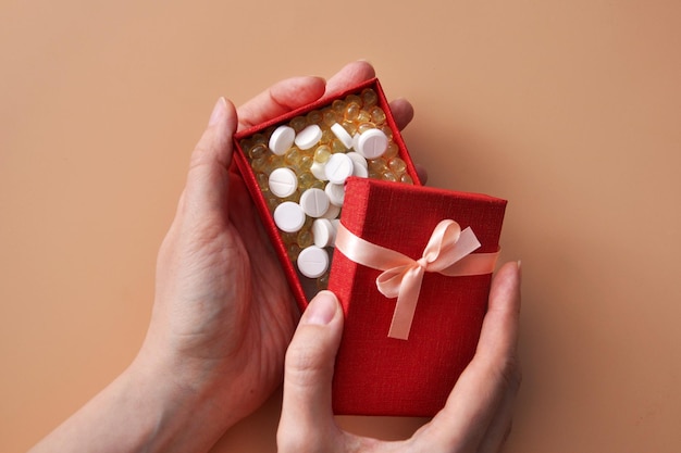 a gift box with pills. Give health