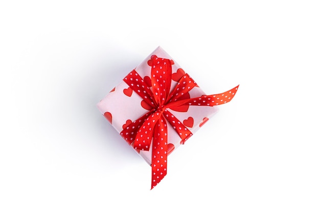 Gift box with red ribbon and hearts isolated on white surface