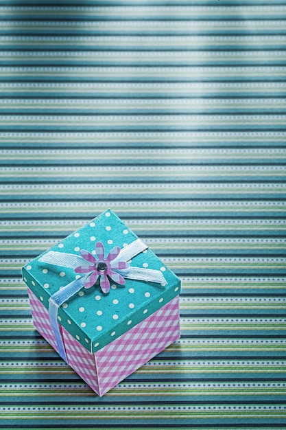 Gift box with ribbon on stripy table cloth celebrations concept