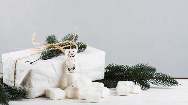 Gift box with snowman from marshmallows 