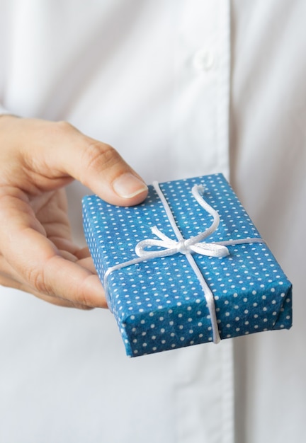 Gift box in womans hands. Christmas concept.