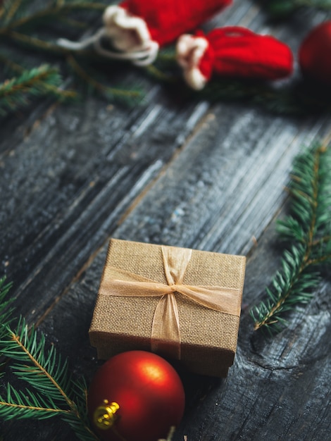 Gift box on wood with Christmas tree branches