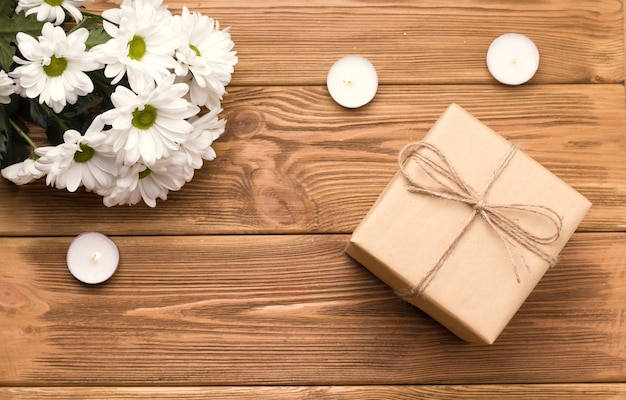 Gift box in a wrapping paper on wooden table