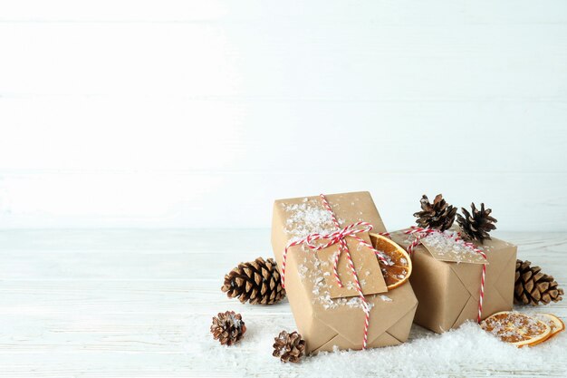 Gift boxes and Christmas accessories on white wooden table