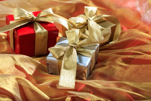 Gift boxes on a golden satin background