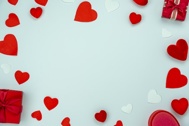 gift boxes and hearts on blue table