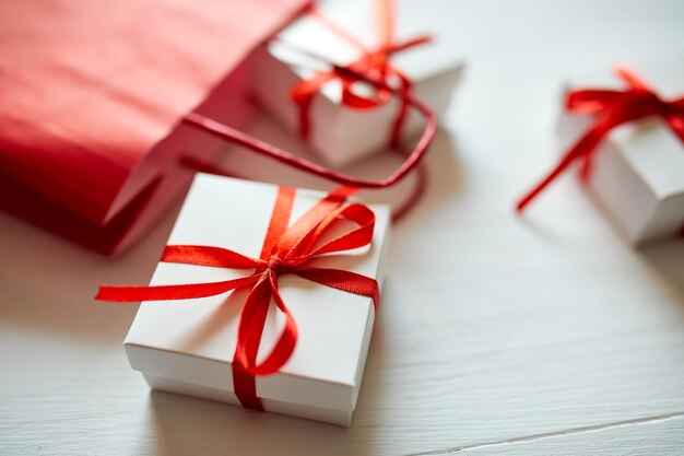 Gift boxes out from red paper bag on white background