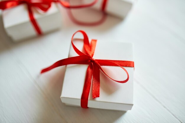 Gift boxes out from red paper bag on white background