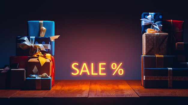 Gift boxes on the table in neon lighting Sale concept