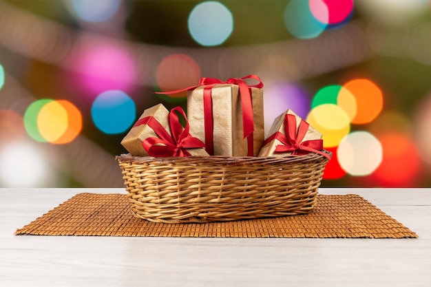 Gift boxes with bows and blurred twinkling party lights