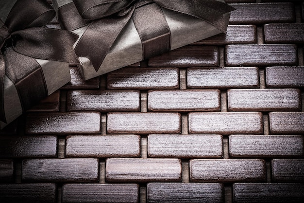 Gift boxes with brown ribbons on wooden mat horizontal version