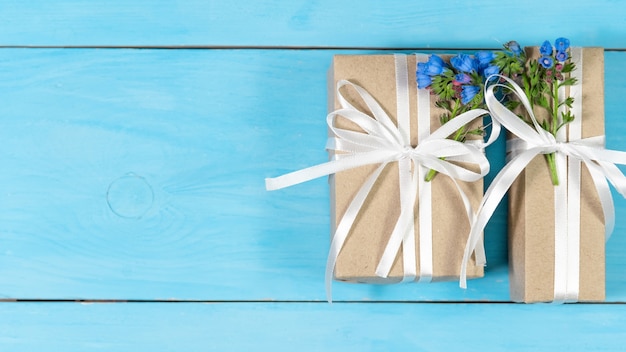 Gift boxes with flowers on a blue background.