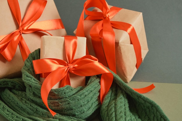 Gift boxes with red ribbons on a green background craft decorations and gifts