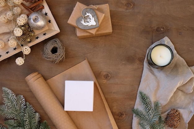 Gift packaging  person holding present box at workplace with craft paper on wooden table