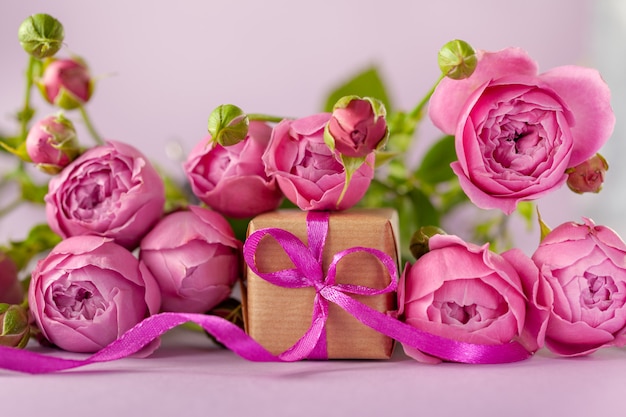 Gift present box with beautiful pink flowers roses bouquet. Concept Mother's Day.