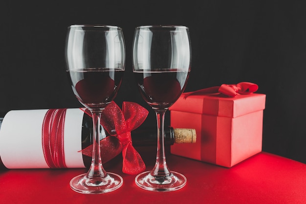 Gift with a bottle of wine and two glasses with red wine