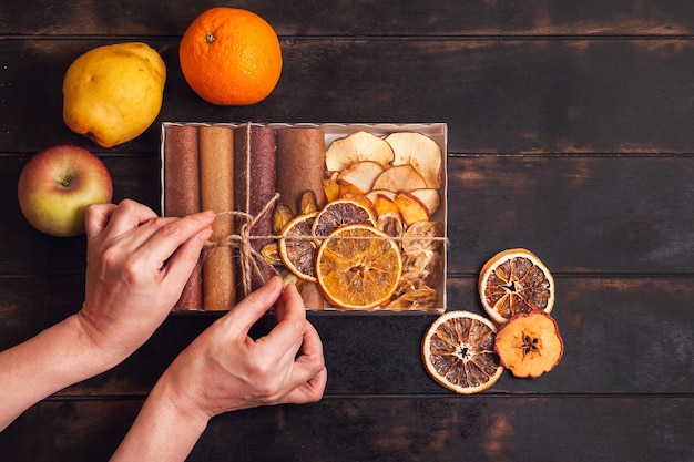 Gift with healthy sweets. Packaging boxes with sweet fruit snacks - pastilles and dried fruit.