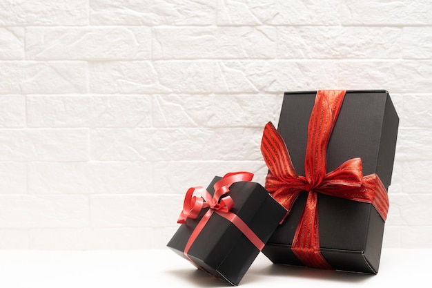 gift with a red ribbon. Black gift box.