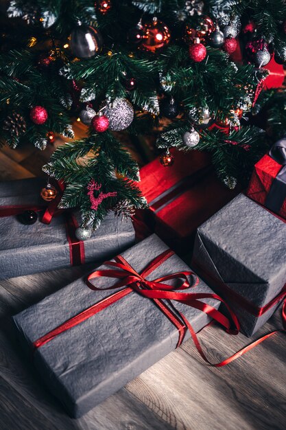 Photo gifts are wrapped in gray under the christmas tree