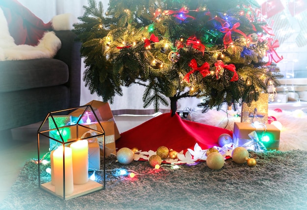 Gifts under beautiful decorated Christmas tree in living room