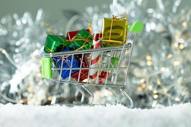 Gifts box in the cart on light bokeh background,