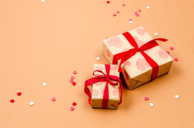 Gifts boxes and hearts on a beige background Valentine's Day concept