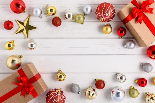 Gifts boxes with festive ribbons and christmas ornament on white wood