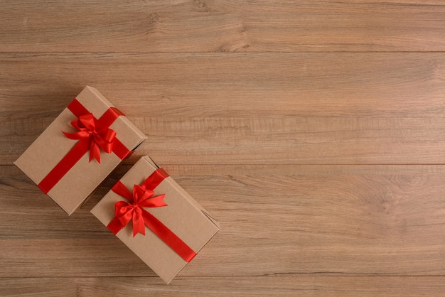 Gifts boxes with festive ribbons on wooden board