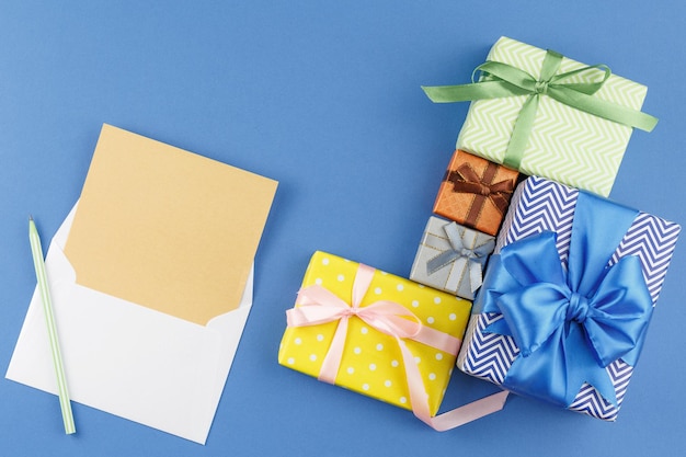 Gifts in colored paper with bows and paper sheet