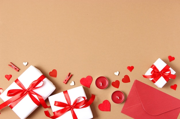 Gifts and hearts on a colored background top view love