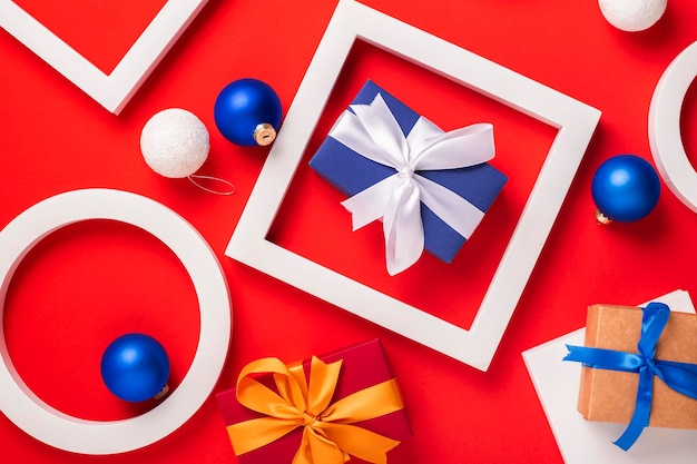 Gifts podium and Christmas toys on a red background Top view flat lay