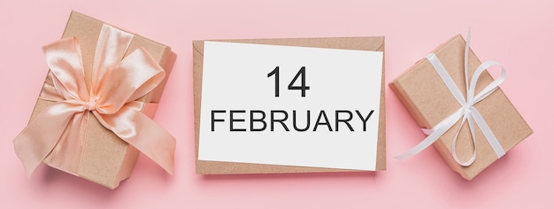 Gifts with note letter on isolated pink background, love and valentine concept with text14 february