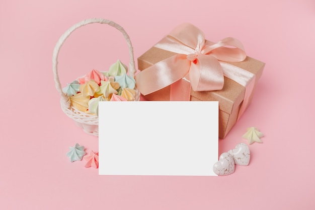 Gifts with note letter on isolated pink background with sweets, love and valentine concept