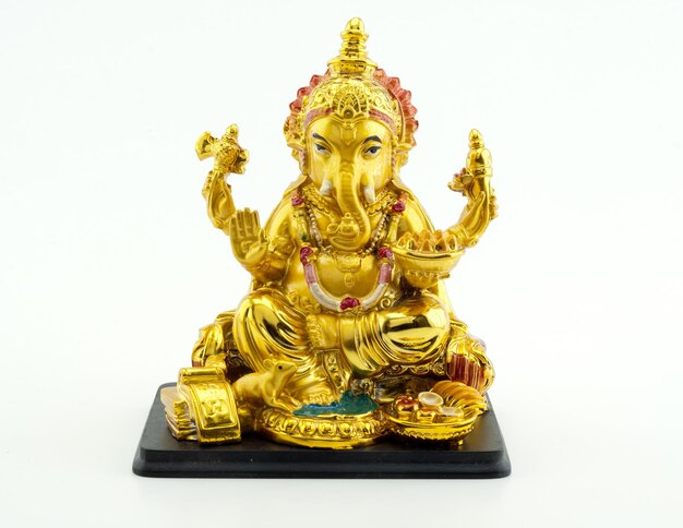 Gilded figure of the elephant Ganesha on white background