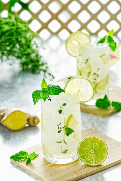 Ginger ale or kombucha in glass homemade cocktail lime and ginger limonade indian drink to refresh