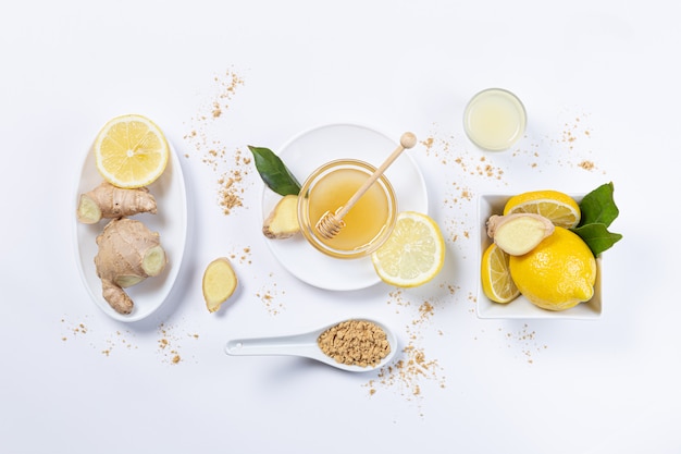 Ginger, honey and lemon,  in white plates and spoon