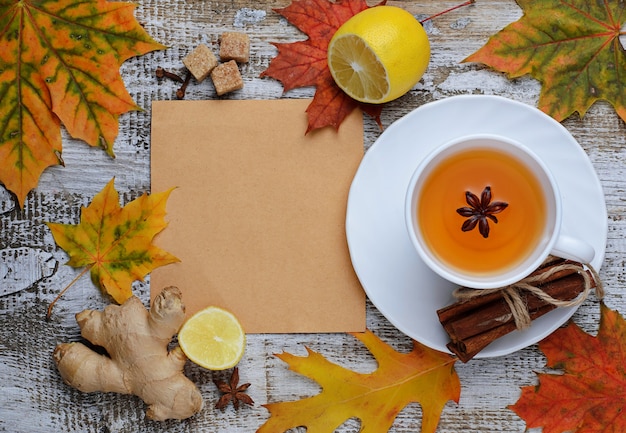 Ginger, lemon and cop of tea on light background