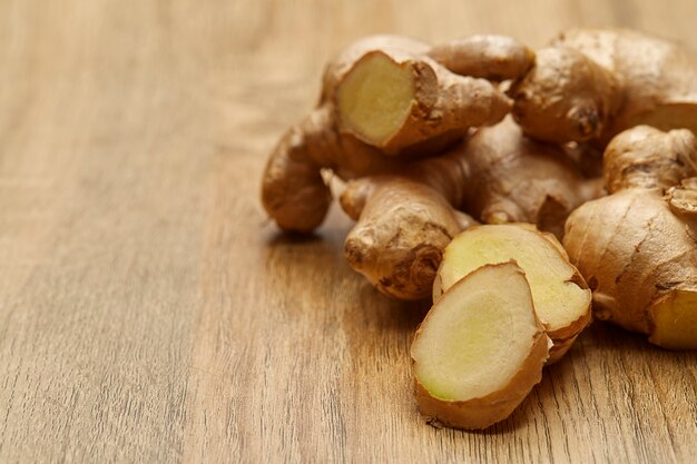 Ginger root sliced on wooden table