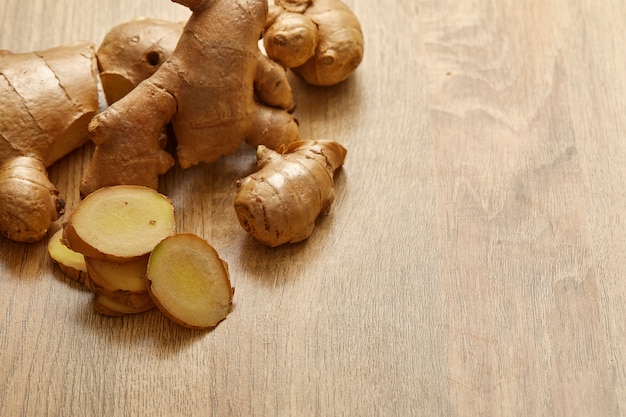 Ginger root sliced on wooden table