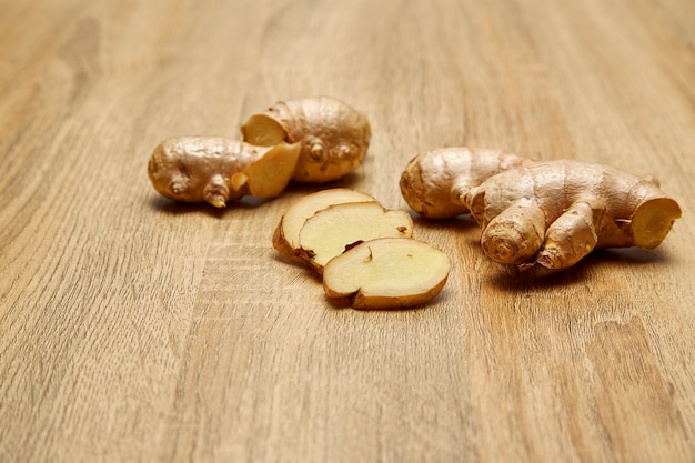 Ginger root sliced on wooden table