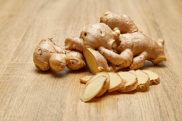 Ginger root sliced on wooden table