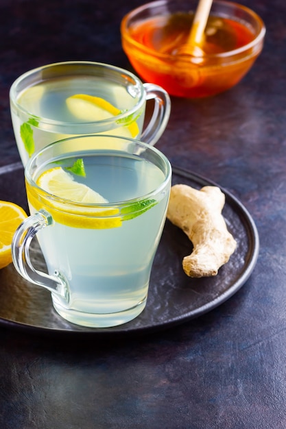 Ginger tea with lemon and mint in glass mugs