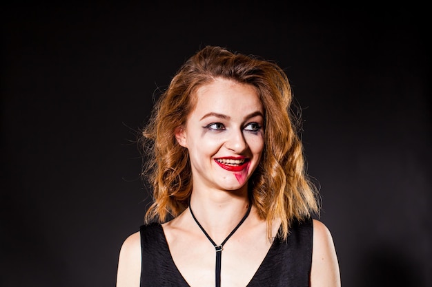 Ginger young woman with dirty face smiling.