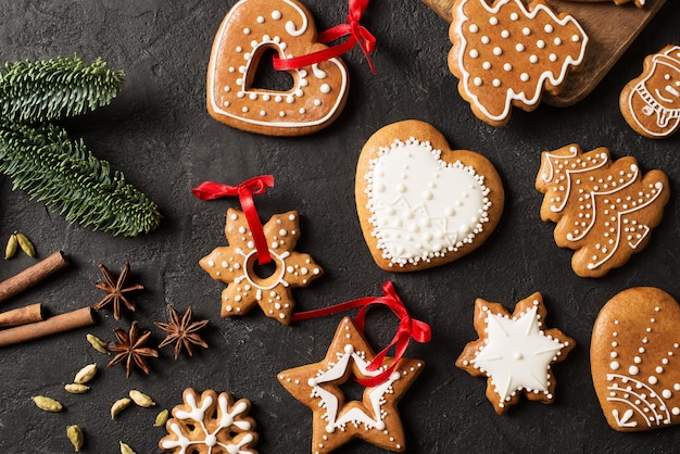 Gingerbread christmas and happy new year cookies background on black texture, copy space