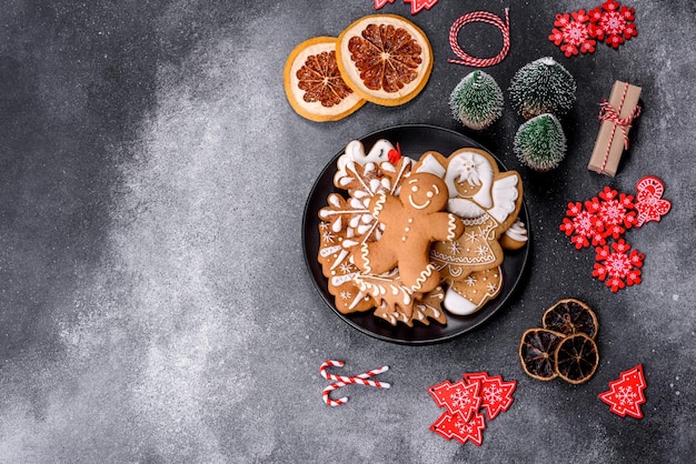 Gingerbread Christmas tree decorations dried citrus fruits on a gray concrete background