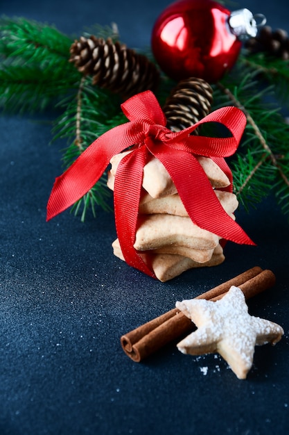 Gingerbread cookie decorated with a red ribbon with a bow and christmas ball